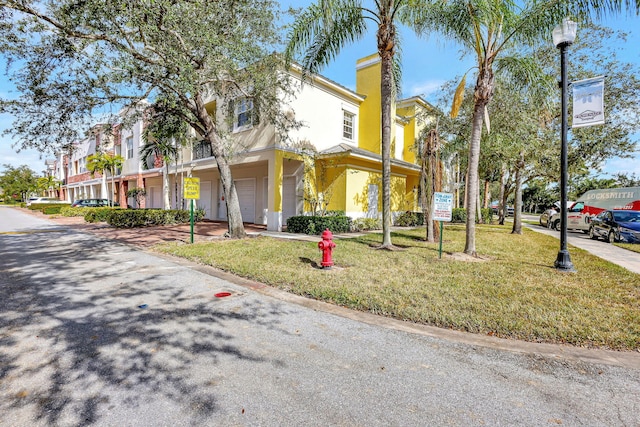 view of front of home with a front lawn and a garage