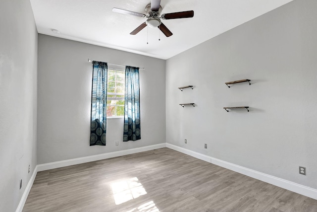 empty room featuring ceiling fan and light hardwood / wood-style flooring