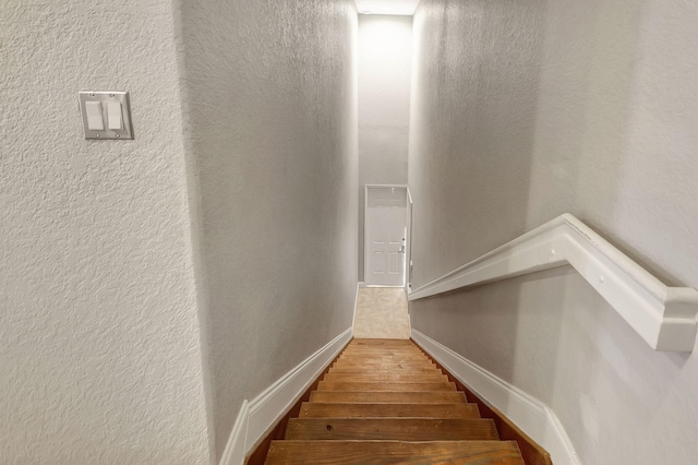 stairs with wood-type flooring