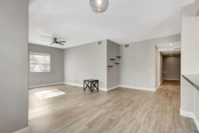 living room with ceiling fan and light wood-type flooring