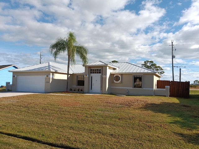 view of front of home with a garage and a front yard