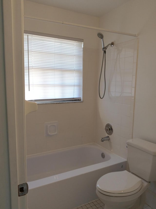 bathroom with  shower combination, tile patterned flooring, and toilet