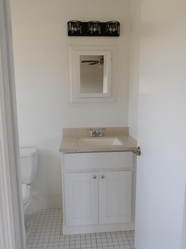 bathroom with toilet, tile patterned floors, ceiling fan, and vanity