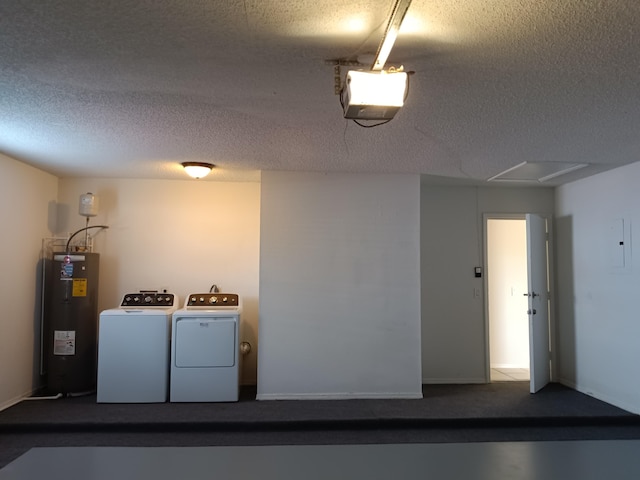 laundry area with washer and clothes dryer, a textured ceiling, and electric water heater