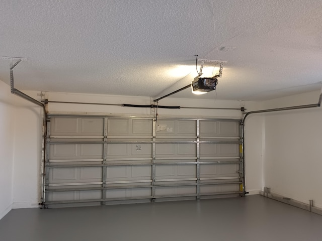 garage with a garage door opener and baseboards