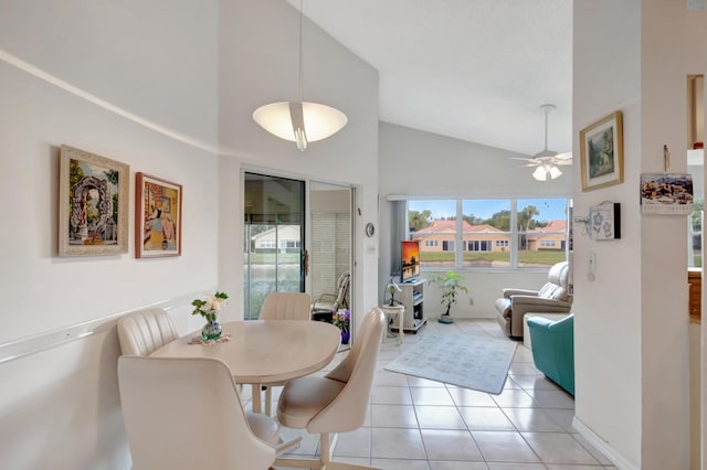 dining area with ceiling fan, light tile patterned floors, and high vaulted ceiling