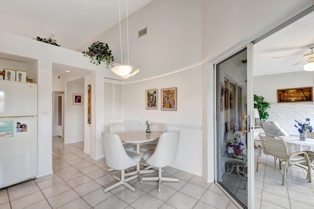 tiled dining area with ceiling fan