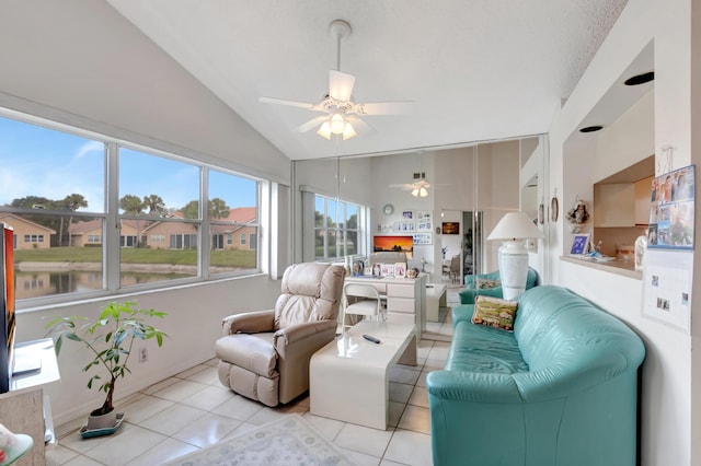 tiled living room with a water view, ceiling fan, and lofted ceiling