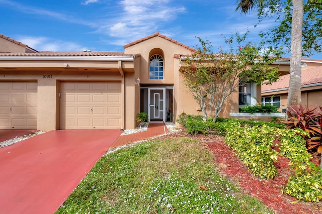 mediterranean / spanish home featuring a garage