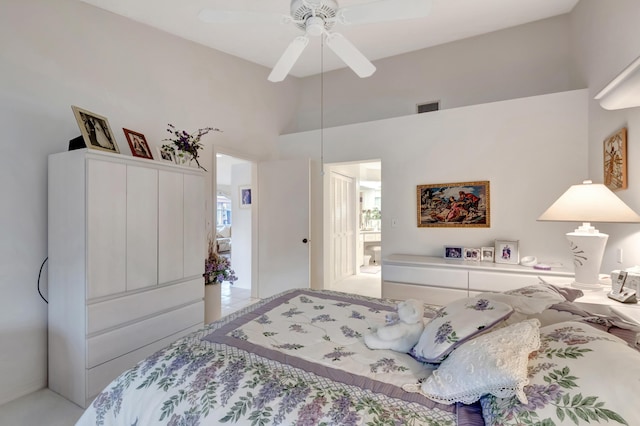 bedroom with ceiling fan and a towering ceiling