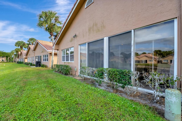 view of side of home featuring a yard