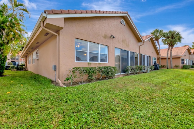 back of property featuring a lawn