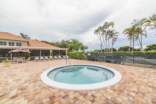 view of pool featuring a patio area and a sunroom