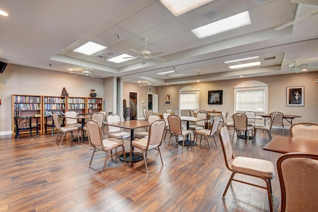 dining space with ceiling fan and dark hardwood / wood-style flooring