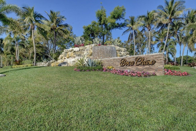 community sign featuring a lawn