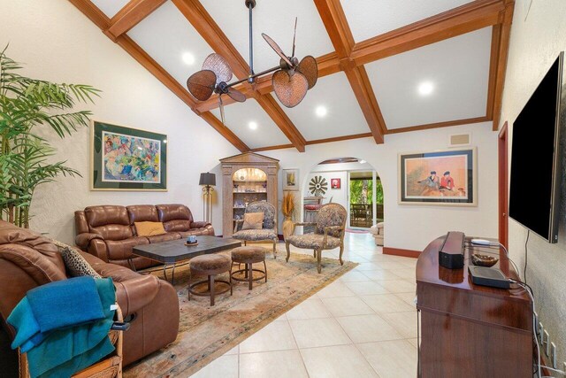 living room featuring beamed ceiling, ceiling fan, light tile patterned floors, and high vaulted ceiling