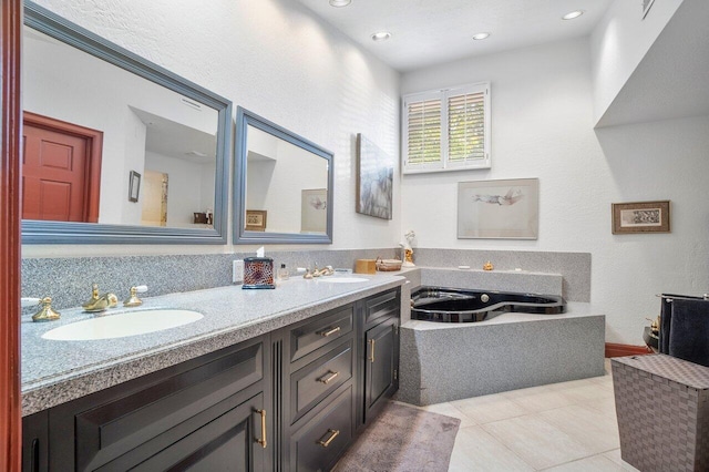 bathroom featuring vanity, tile patterned floors, and a bathtub