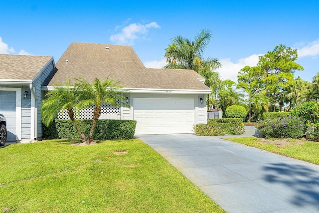 view of front of house with a front yard and a garage