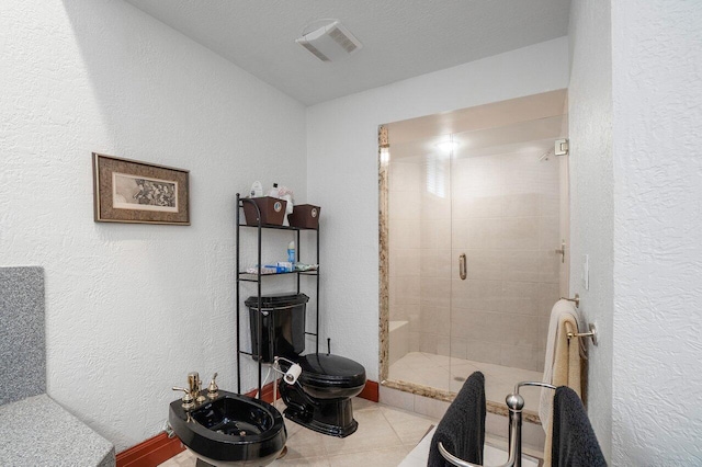 bathroom with tile patterned floors, walk in shower, a textured ceiling, a bidet, and toilet