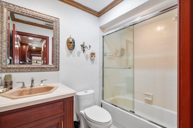 full bathroom featuring toilet, vanity, enclosed tub / shower combo, and ornamental molding