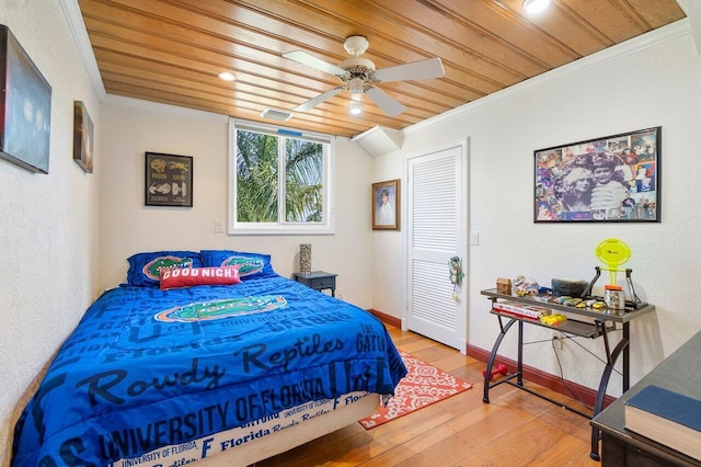 bedroom with hardwood / wood-style flooring, ceiling fan, ornamental molding, and wood ceiling