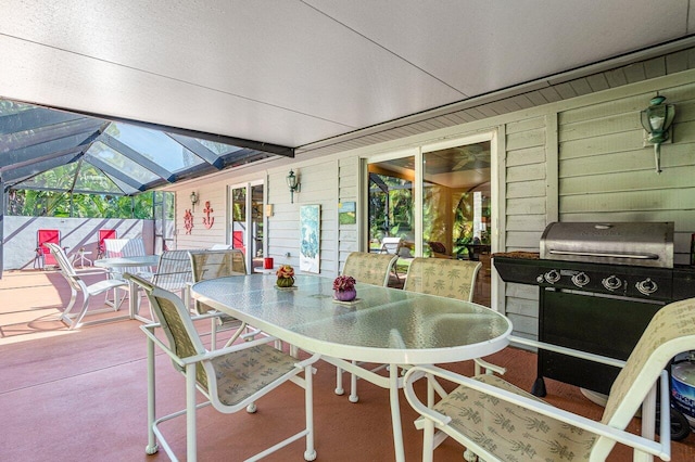 view of patio / terrace featuring glass enclosure and area for grilling