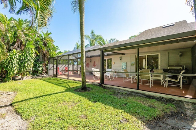 view of yard featuring glass enclosure and a patio area