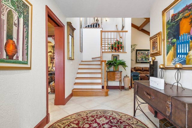 foyer with light tile patterned floors and a textured ceiling