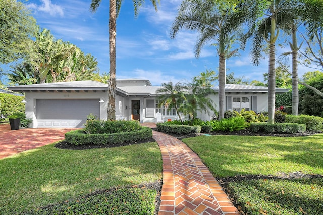 ranch-style home with a front lawn and a garage