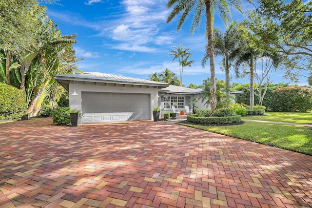 ranch-style house with a garage and a front lawn