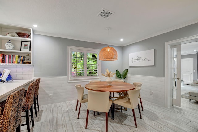 dining room featuring crown molding