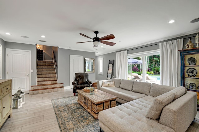 living room with ceiling fan, ornamental molding, and light wood-type flooring