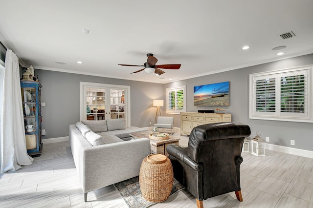 living room featuring ceiling fan, crown molding, a healthy amount of sunlight, and light hardwood / wood-style flooring