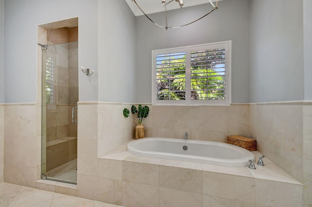 bathroom featuring shower with separate bathtub