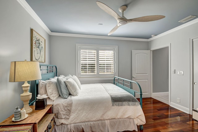 bedroom featuring ceiling fan, dark hardwood / wood-style flooring, and crown molding