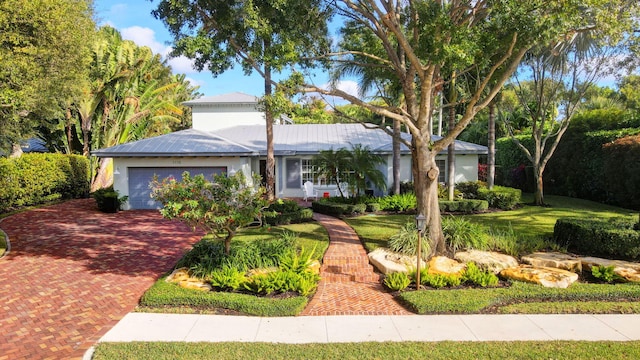 ranch-style home featuring a front yard and a garage