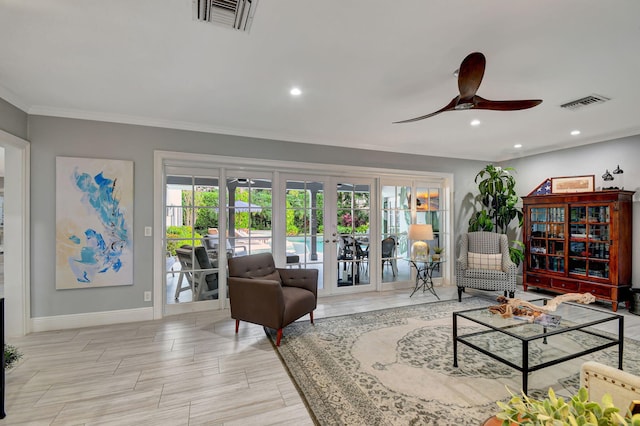 living room with french doors, ceiling fan, and crown molding