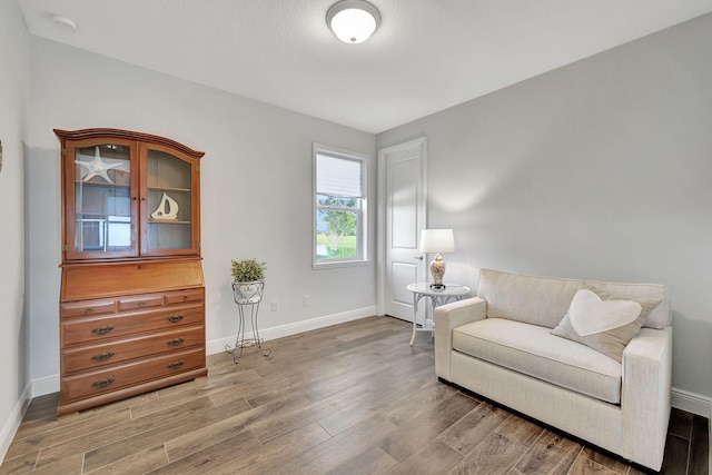 living area featuring light wood-style flooring and baseboards