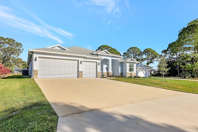 view of front of property featuring central AC unit, driveway, a front lawn, and an attached garage