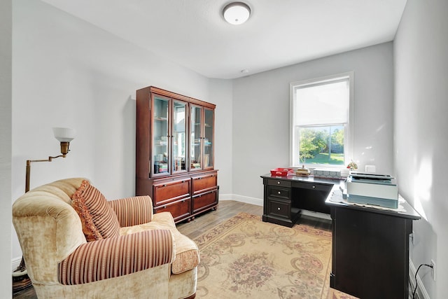 home office with light hardwood / wood-style floors