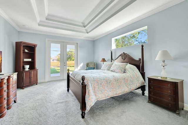 bedroom with light colored carpet, ornamental molding, access to outside, a tray ceiling, and french doors