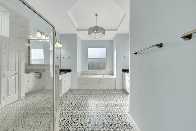 full bath featuring a garden tub, vanity, baseboards, tiled shower, and a tray ceiling