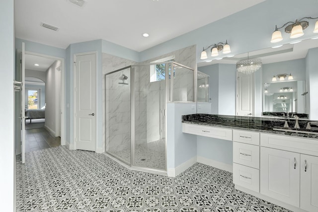 bathroom featuring vanity and a shower with shower door