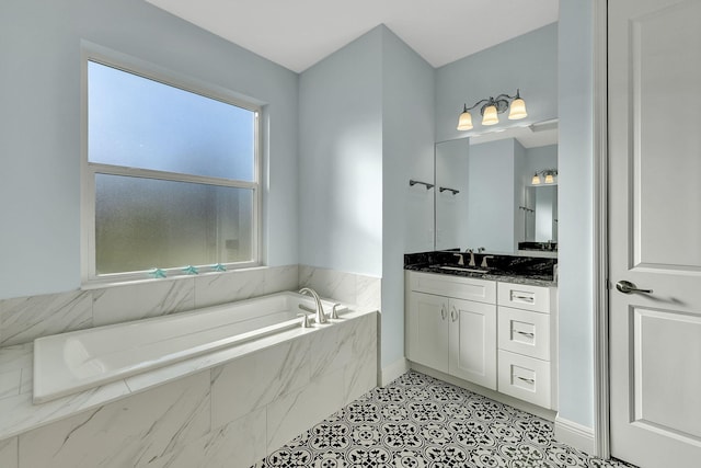 full bath featuring tile patterned floors, vanity, baseboards, and a bath