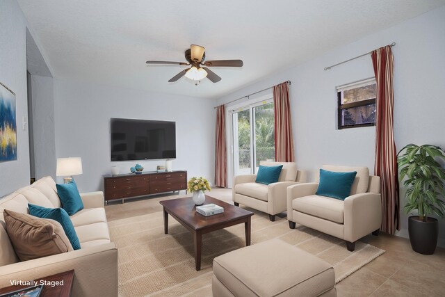 spare room featuring light tile patterned floors, ceiling fan, and baseboards