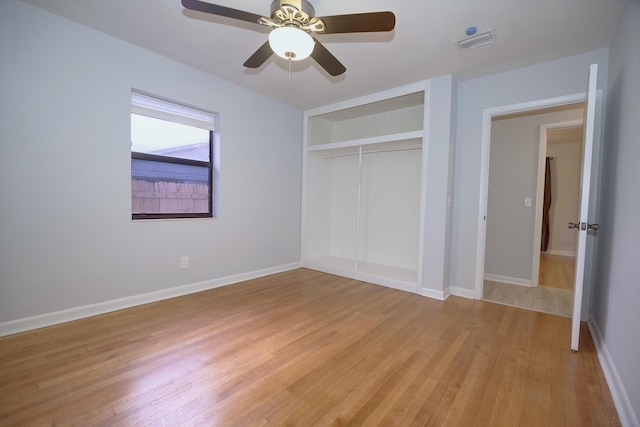 unfurnished bedroom featuring light wood-style flooring, a closet, visible vents, and baseboards