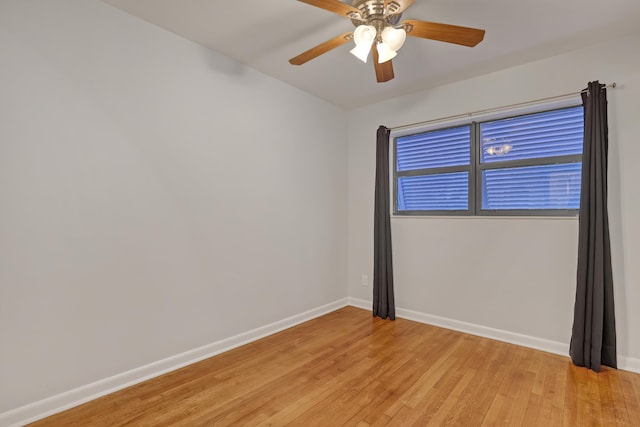 unfurnished room featuring ceiling fan, light wood-style flooring, and baseboards