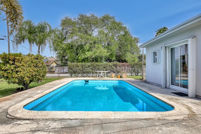 view of swimming pool with fence, a fenced in pool, and a patio