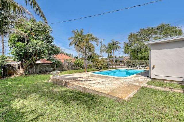 view of swimming pool featuring a yard, a patio, a fenced backyard, and a fenced in pool