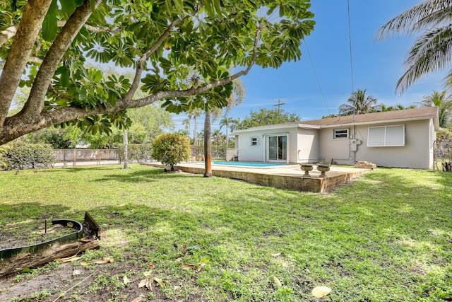 view of yard featuring fence and a patio